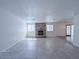 Spacious living room featuring tile flooring, a brick fireplace, and ample natural light through large windows at 3667 Descanso St, Las Vegas, NV 89121