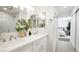 Stylish bathroom with double sinks, modern fixtures, and decorative greenery at 3915 Wesvan Ct, Las Vegas, NV 89121