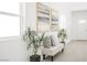 Inviting entryway featuring a bench, plants, and modern art for a stylish first impression at 3915 Wesvan Ct, Las Vegas, NV 89121