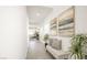 Bright hallway showcasing modern art, a bench, and access to living spaces at 3915 Wesvan Ct, Las Vegas, NV 89121