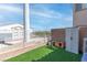 Backyard area with artificial turf, dog house and storage shed at 4014 Sparrow Rock St, Las Vegas, NV 89129