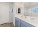 Bright bathroom features a double sink vanity with modern fixtures, and walk-in shower at 4014 Sparrow Rock St, Las Vegas, NV 89129