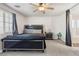 Bedroom features a ceiling fan, window with blinds, carpeting, and well-appointed furnishings at 4014 Sparrow Rock St, Las Vegas, NV 89129