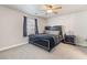 Bedroom features a ceiling fan, window with blinds, carpeting, and well-appointed furnishings at 4014 Sparrow Rock St, Las Vegas, NV 89129