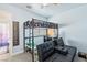 Well-lit bedroom features a loft bed, a desk, and a comfortable seating area at 4014 Sparrow Rock St, Las Vegas, NV 89129