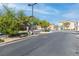 Gated entrance to the community with lush landscaping and secure access at 4014 Sparrow Rock St, Las Vegas, NV 89129