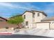 Inviting two-story home featuring a two-car garage, stucco facade, and xeriscaped front yard at 4014 Sparrow Rock St, Las Vegas, NV 89129