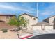 Charming home featuring a three-car garage, complemented by a xeriscaped front yard with a beautiful tree at 4014 Sparrow Rock St, Las Vegas, NV 89129