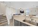Bright kitchen with stainless steel appliances flowing into the living room and stairway at 4014 Sparrow Rock St, Las Vegas, NV 89129