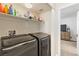 Convenient laundry area with modern washer and dryer, and plenty of storage shelves at 4014 Sparrow Rock St, Las Vegas, NV 89129