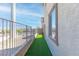 Side yard with artificial turf and privacy fence at 4014 Sparrow Rock St, Las Vegas, NV 89129