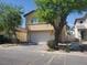 Two-story home featuring a white garage door and desert landscaping at 4356 Pittsfield St, Las Vegas, NV 89115