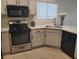 Bright kitchen features white cabinets, stainless steel appliances, and tiled floor at 4356 Pittsfield St, Las Vegas, NV 89115