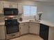 This bright kitchen features white cabinets, stainless steel appliances, and tiled floors at 4356 Pittsfield St, Las Vegas, NV 89115