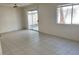 Bright living room with tiled floor, a sliding glass door and window at 4356 Pittsfield St, Las Vegas, NV 89115