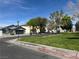 Street view of neighborhood with sidewalks, grass and trees, with homes on either side at 4356 Pittsfield St, Las Vegas, NV 89115