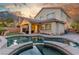 Gorgeous backyard with pool, spa, covered patio, outdoor kitchen, and beautiful landscaping at 4573 Milvio Ave, Las Vegas, NV 89141