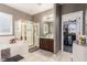 Bright bathroom features glass shower, soaking tub, and walk-in closet access at 4573 Milvio Ave, Las Vegas, NV 89141