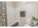 Full bathroom with white tile shower, shower curtain, toilet, and towel rack at 4573 Milvio Ave, Las Vegas, NV 89141
