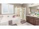 Bright bathroom with soaking tub, glass shower, and double vanity sink at 4573 Milvio Ave, Las Vegas, NV 89141
