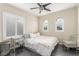 Cozy bedroom with white bedding, mirrored nightstand, and natural light at 4573 Milvio Ave, Las Vegas, NV 89141