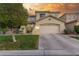 Charming two-story home with a well-maintained lawn, mature trees, and a two-car garage at 4573 Milvio Ave, Las Vegas, NV 89141