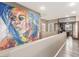 Bright hallway featuring artistic wall painting, wood floors, and a study room at 4573 Milvio Ave, Las Vegas, NV 89141