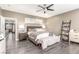 Well-lit main bedroom with ceiling fan, gray walls, and en suite bathroom access at 4573 Milvio Ave, Las Vegas, NV 89141