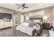 Spacious main bedroom with modern ceiling fan, dresser, and ensuite bathroom access at 4573 Milvio Ave, Las Vegas, NV 89141