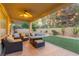 Relaxing covered patio featuring comfortable seating and manicured lawn overlooking the pool at 4573 Milvio Ave, Las Vegas, NV 89141