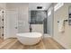 Spa-like bathroom featuring a modern soaking tub, a glass-enclosed shower, and high-end finishes at 4574 Fiore Bella Blvd, Las Vegas, NV 89135