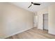Bright bedroom with light wood floors, ceiling fan, closet, and door to another room at 4574 Fiore Bella Blvd, Las Vegas, NV 89135