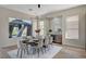 Dining room features stylish decor, modern lighting, and a view of the backyard at 4574 Fiore Bella Blvd, Las Vegas, NV 89135