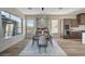 Dining room with an elegant dining set, a large window, and a stylish bar area at 4574 Fiore Bella Blvd, Las Vegas, NV 89135