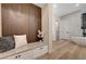 Hallway featuring a built-in bench with storage and a view into a luxurious bathroom at 4574 Fiore Bella Blvd, Las Vegas, NV 89135