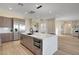 Open-concept kitchen with a spacious island, stainless steel appliances, and wood flooring at 4574 Fiore Bella Blvd, Las Vegas, NV 89135
