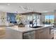 Spacious modern kitchen with an island, stainless steel appliances, and modern lighting at 4574 Fiore Bella Blvd, Las Vegas, NV 89135