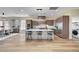 Open kitchen and dining area featuring a kitchen island, stainless appliances, and barstool seating at 4574 Fiore Bella Blvd, Las Vegas, NV 89135
