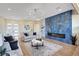 Open concept living room featuring a blue tile wall, built in shelving, and modern lighting at 4574 Fiore Bella Blvd, Las Vegas, NV 89135