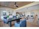 Open-concept layout showcasing the living room and dining area with light wood floors and sophisticated decor at 4574 Fiore Bella Blvd, Las Vegas, NV 89135
