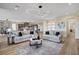 Open living space with modern lighting, hardwood flooring, and a clear view of the kitchen at 4574 Fiore Bella Blvd, Las Vegas, NV 89135