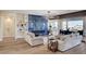 Bright living room with fireplace and modern lighting, open to dining and kitchen at 4574 Fiore Bella Blvd, Las Vegas, NV 89135