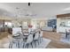 An open living and dining area with modern decor, hardwood floors, and built-in shelving at 4574 Fiore Bella Blvd, Las Vegas, NV 89135