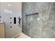 Luxurious shower featuring marble-style tile and multiple shower heads at 4574 Fiore Bella Blvd, Las Vegas, NV 89135