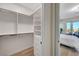 Bright walk-in closet with custom shelving and drawers, conveniently located off the main bedroom at 4574 Fiore Bella Blvd, Las Vegas, NV 89135
