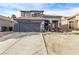 Inviting two-story house with a spacious driveway and desert landscaping, ideal for comfortable living at 4919 Rancho Domingo Ct, North Las Vegas, NV 89031