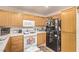 Well-equipped kitchen with oak cabinets, white appliances, and ample counter space, ready for your culinary adventures at 4919 Rancho Domingo Ct, North Las Vegas, NV 89031