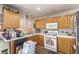 Efficient kitchen featuring oak cabinets, white countertops, and essential appliances, designed for practicality at 4919 Rancho Domingo Ct, North Las Vegas, NV 89031