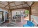 Outdoor living space featuring a built-in grill, covered patio, hot tub, and comfortable seating at 4992 W Moberly Ave, Las Vegas, NV 89139