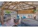 Relaxing backyard patio with a covered pergola, hot tub, and comfortable seating area at 4992 W Moberly Ave, Las Vegas, NV 89139